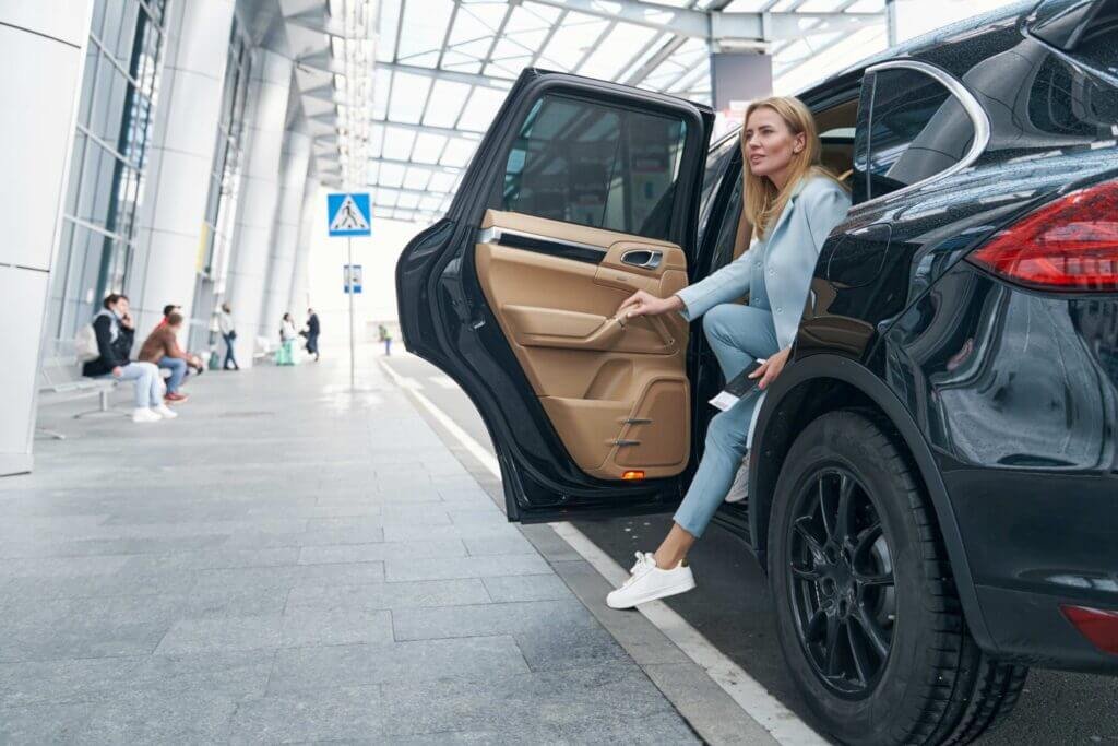 Woman stepping out of a black luxury SUV with American Car Service New Jersey.
